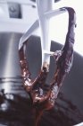 Closeup view of chocolate cake mixture on whisk — Stock Photo