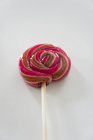 Closeup view of striped lolly on white surface — Stock Photo