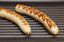 White sausages on a grill — Stock Photo