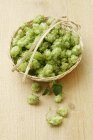 Elevated view of hops umbels in a wicker basket — Stock Photo