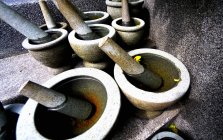 Elevated view of stone mortars with water and pestles — Stock Photo