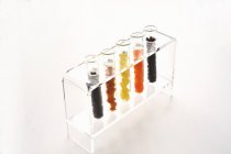 Various dried fruits in test tubes over white surface — Stock Photo