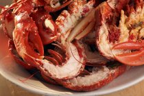 Closeup view of cooked and halved lobsters and prawns — Stock Photo