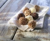 Chocolate truffles on towel — Stock Photo