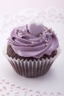 Chocolate cupcake with blackberry icing — Stock Photo
