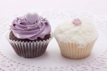 Cupcake with blackberry icing and grated coconut — Stock Photo