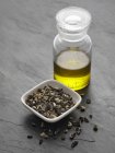 Elevated view of chopped Comfrey root and Comfrey oil in glass bottle — Stock Photo