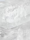 Closeup view of ice block on reflective surface — Stock Photo