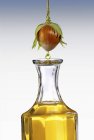Closeup view of hazel nut oil dropping from a hazel nut into a carafe — Stock Photo