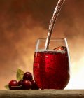 Pouring cherry juice — Stock Photo