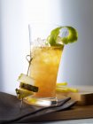 Closeup view of iced Mai Tai cocktail with lime peel and pineapple slices — Stock Photo