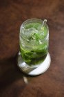 Mojito cocktail on coaster and on table — Stock Photo