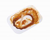 Elevated view of empty container with currywurst remains — Stock Photo