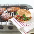 Closeup view of grilled chicken burger on towel — Stock Photo