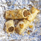 Closeup view of sausage rolls on metal foil — Stock Photo