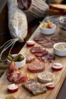 Elevated view of Planchette de Charcuterie with wild boar Salami, pates,Terrines and pickles — Stock Photo