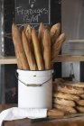 Fresh Baguettes in bucket — Stock Photo