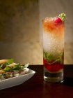 Closeup view of Verona Swizzle in a glass by dish — Stock Photo