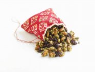 Closeup view of homemade trail mix spilling from a cloth bag — Stock Photo