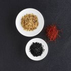 Top view of various spices on a slate platter — Stock Photo
