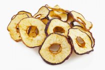 Closeup view of dried apple rings on white background — Stock Photo