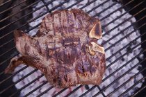 T-bone steak on a barbecue — Stock Photo