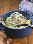 Mashed potatoes with herbs in pot — Stock Photo