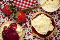 Halved scone topped with clotted cream — Stock Photo