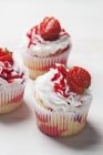 Three marble strawberry cupcakes — Stock Photo