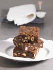 Stack of chocolate brownies with nuts — Stock Photo