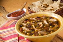 Closeup view of chicken tortilla soup with Salsa and Tortilla chips — Stock Photo