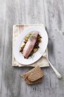 Top view of soused herring fish on lentils — Stock Photo