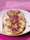 Closeup view of Tarte flambee with apples and red onions — Stock Photo