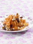 Carrot salad with dates and almonds over colored tablecloth — Stock Photo