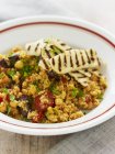Couscous with chickpeas, chorizo and grilled haloum — Stock Photo