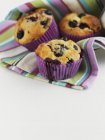 Blueberry muffins in stripped cloth — Stock Photo