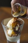 Espresso being pored over ice cream — Stock Photo