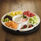 Closeup view of fresh fruit platter with dipping sauces — Stock Photo