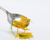 Closeup view of orange, lemon and lime zest on spoon — Stock Photo
