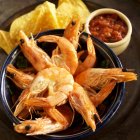 Vue rapprochée de crevettes entières avec croustilles de tortilla et salsa — Photo de stock