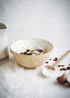 Bowl of flour and raisins — Stock Photo