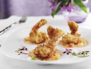 Closeup view of coconut crusted tiger shrimp with sweet and sour sauce — Stock Photo