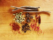 Top view of various spices on wooden surface — Stock Photo