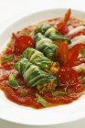 Chard stuffed with couscous in a tomato ragout on white plate — Stock Photo