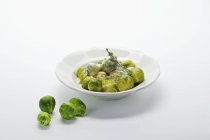 Brussels sprouts in sauce — Stock Photo