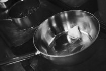 Vista close-up de manteiga derretendo em uma panela no fogão — Fotografia de Stock