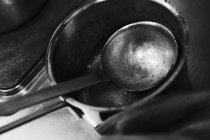 Closeup view of dirty saucepan and ladle — Stock Photo