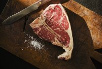 Porterhouse steak on board — Stock Photo