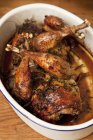 Elevated view of roast pheasant in an oven dish — Stock Photo
