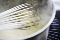 Closeup view of creamed mushroom soup in bowl with whisk — Stock Photo